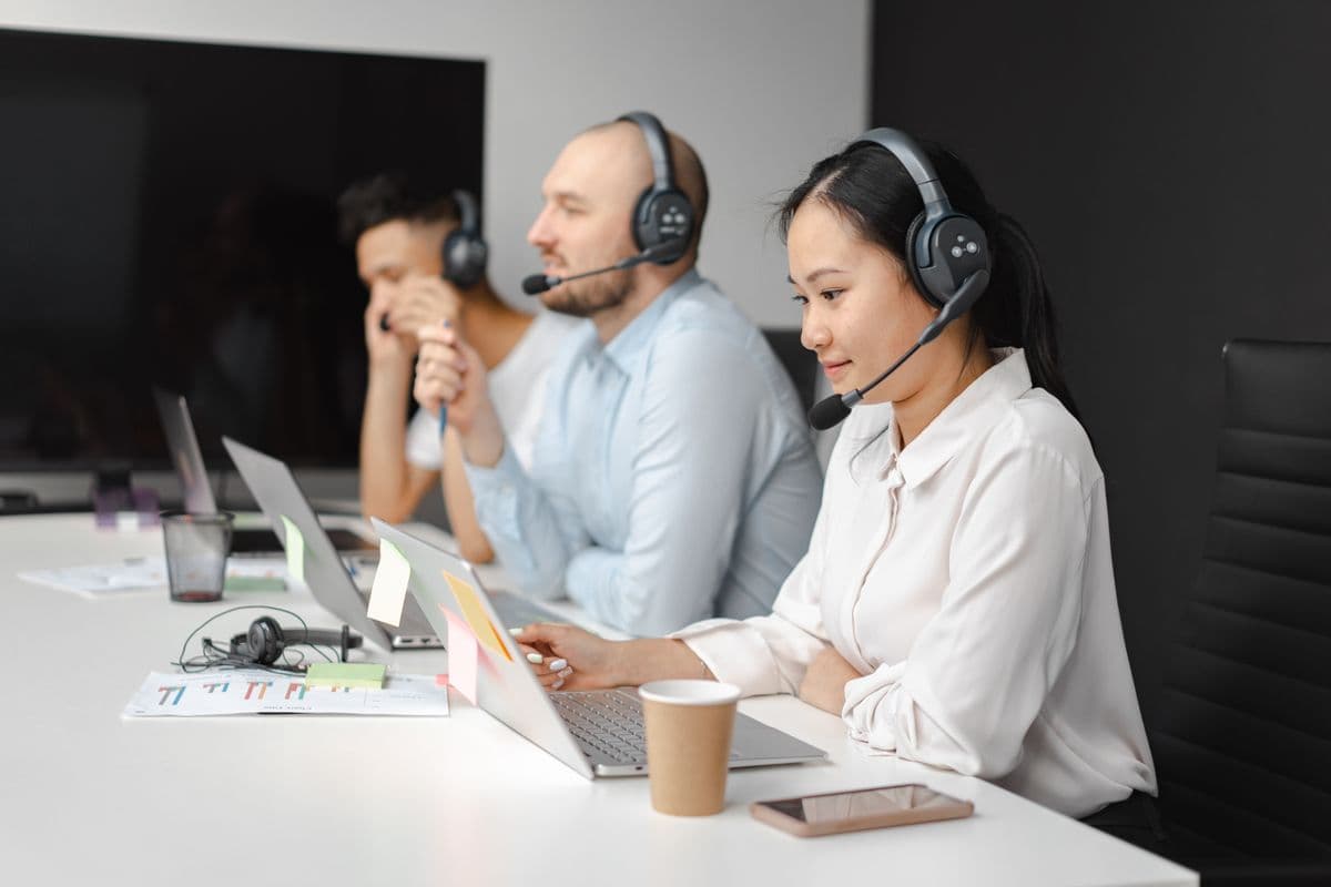 Customer success team coordinating software support in a meeting room