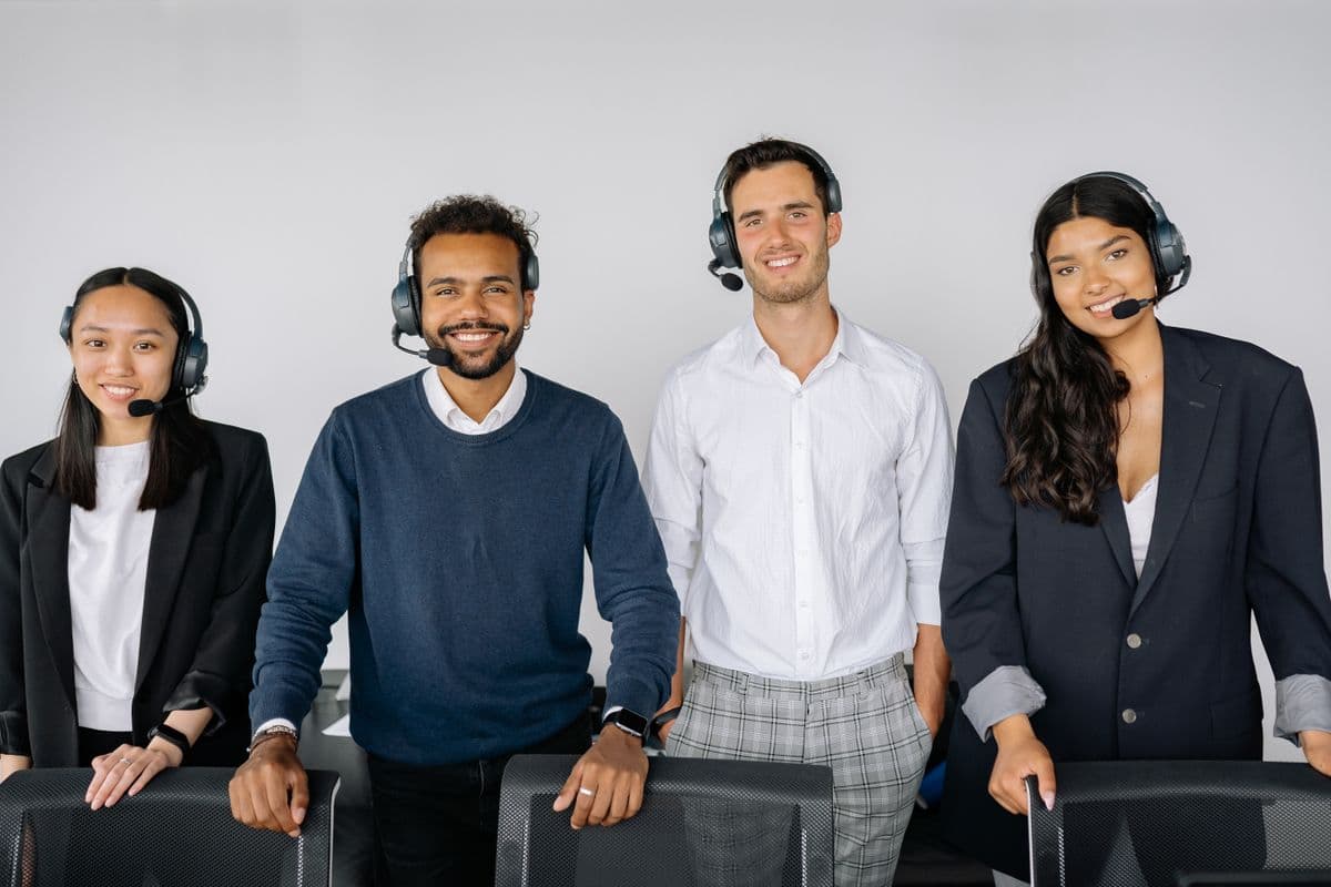 International customer support team wearing headsets in a modern office